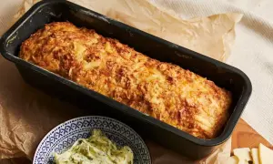 Złocista babka ziemniaczana w keksówce, obok miseczka z ziołowym masłem. Idealna na rodzinny obiad.